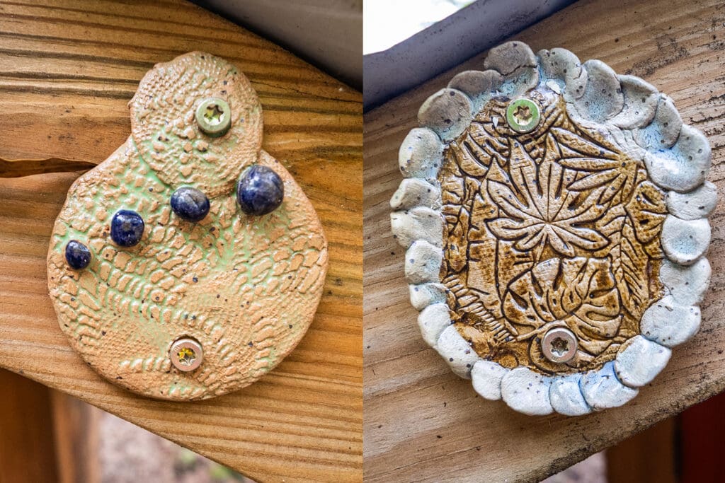 Abstract clay disks fixed to the wooden beam of a structure