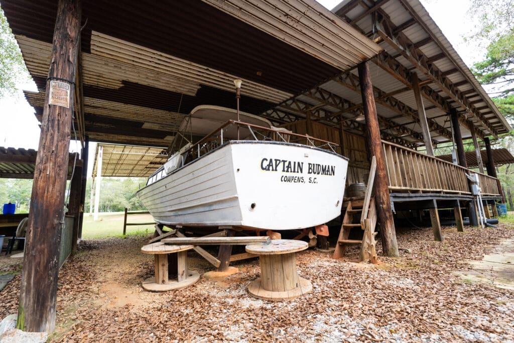 A boat named "Captain Budman" sits underneath the Greenfield Excursion structure