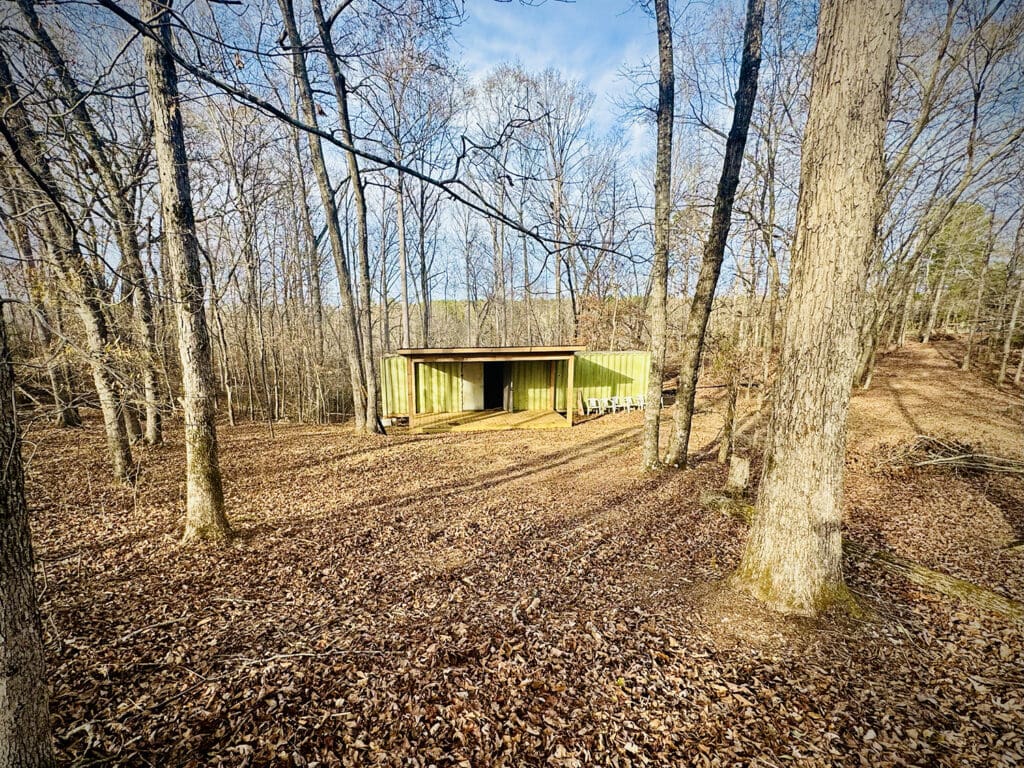An amphitheater in the woods, the stage made from a repurposed shipping container