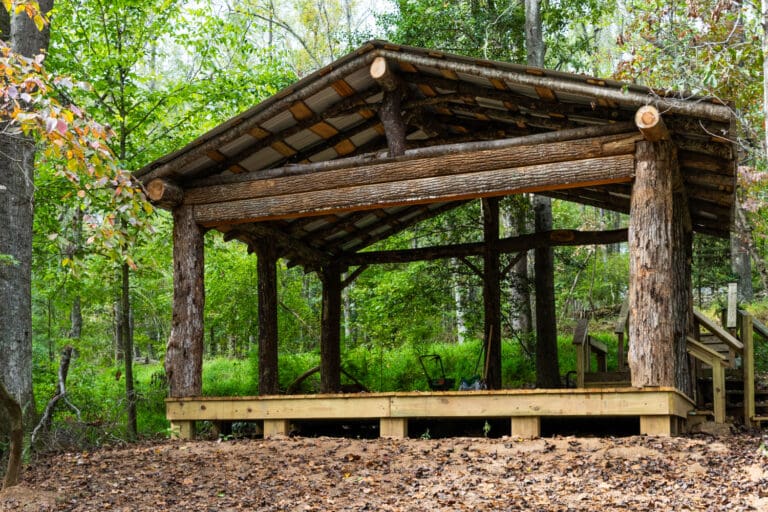 A stage in the woods made from trees that fell during Hurricane Helene